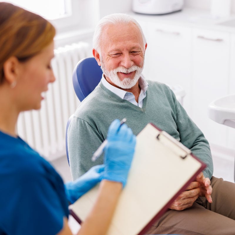 man talking with dentist